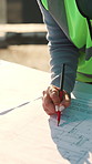 Woman, architect and hands with blueprint for drawing, planning renovation and expansion project. Floorplan, draft and engineer at site for property development, circle design or structural reference
