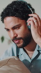 Happy, music and man on sofa with headphones for streaming, playlist and audio subscription. Relax, home and person with tech for listening to radio, song and podcast for break, chill and weekend