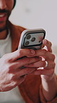 Laugh, phone and hands in home with message, online communication and comic post on social media. Typing, space and happy man in house with technology, funny text and meme reaction on chat app.