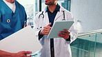 Doctor, nurse and hands by tablet in hospital for medical advice, research and telehealth app. People, technology and internet connection at clinic with discussion of results, teamwork and planning