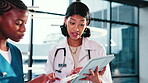 Doctor, nurse and tablet in hospital with talking for medical advice, research and telehealth app. Women, technology and internet connection at clinic with results, teamwork and planning online