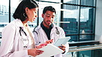 Doctors, people and tablet in hospital with talking for medical advice, research and telehealth app. Man, woman and tech for internet connection at clinic with results, teamwork and planning online