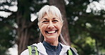 Happy, face and old woman hiking in nature with fitness, travel or fresh air for retirement wellness. Bokeh, senior person smile and journey outdoor in forest with trekking, adventure and good mood.