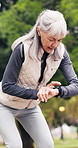 Senior, fitness and woman with watch in nature for tracking heart rate, calories or workout goals. Active, elderly or female person checking wristwatch for outdoor exercise, recovery or rest in park