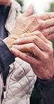 Senior, person and hands with wrist pain in nature for overworked strain, pressure or injury. Active, elderly or sore arm with discomfort for muscle tension, fitness accident or fibromyalgia in park