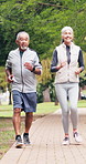 Senior, couple and running with partner in park for outdoor workout, exercise or training together. Active, elderly man and woman talking on path for cardio fitness, health or wellness in nature