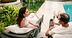 Couple, chat and relax with wine, resort and laughing with partner and bonding together on holiday. Above, hospitality and happy mature people with alcohol, connection or funny discussion on vacation
