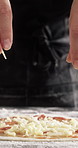 Cooking, pizza and hands of chef with cheese in restaurant for catering with dough for meal. Ingredients, tomato sauce and culinary worker with food production for Italian cuisine in kitchen at diner