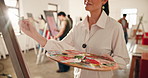 Painter, hands and painting on canvas with palette for inspiration, talent or creative process. Artist, art and woman with brush stroke for artistic design, artwork color or drawing in studio class