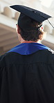 College, graduation or man on campus with thinking, daydream or reflection on academic achievement. University, walking or student with back, success perspective or goal mindset at farewell ceremony.