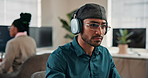 Coding, headphones or man in agency with glasses, radio streaming or debug error in web review. Serious, eyewear or software engineer with tech, code correction or programming assessment with music.
