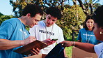 Volunteer, team and boxes with checklist in outdoor park for donation or charity organization. Group, people or NGO with clothing, packages or clipboard for community service or outreach in nature