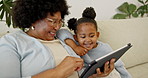 Grandmother, child and play in house with tablet, online game and bonding together for weekend visit. Happy, senior black woman and girl grandchild in home with tech, discussion and app for gaming.