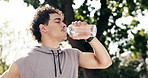 Fitness, man and relax at park with drinking water, post workout hydration and break for cool down. Thinking, thirsty athlete and rest outdoor with refreshing liquid, exercise recovery and wellness