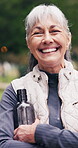 Fitness, face and old woman with arms crossed, laughing or pride for health after physical activity. Outdoor, portrait and senior person with water on break, happy and exercise for wellness at park