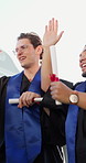 Smile, students and high five at campus for graduation, ceremony and diploma for degree completion. Below, people or celebrate outdoor with applause, academic success and award for learning milestone