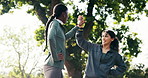 Happy, friends and high five in nature with fitness goals, exercise break and support for wellness. Low angle, women and celebration outdoor with runner personal best success, training and bokeh.