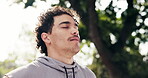 Fitness, man and deep breath at park with meditation, stress relief and calm nervous system. Mindfulness, yogi and exhale for inner peace, holistic breathwork and grounding exercise with fresh air