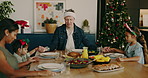 Christmas, family and praying with children for food, festive celebration or gratitude together. Mom, dad and kids holding hands on dining table for December holiday or thankful gathering in house