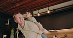 Happy, father and piggyback with child in home for holiday break, weekend or bonding together. Dad, son or carrying kid with smile or love for fun childhood, free time or playful parenting in house