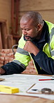 Carpenter, man and review in workshop with blueprint, problem solving and furniture production idea. Mature, black person and thinking in factory with carpentry design document, plan and evaluation.
