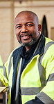 Construction, face or black man on site with smile, contractor or pride in building industry. Portrait, happy or engineer with about us, industrial worker or confidence in infrastructure development.