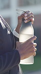 Person, hands and fitness with water bottle for workout break, rest or outdoor hydration in park. Active, mineral or liquid with vitamins or nutrition for sustainability, health or wellness in nature