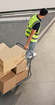 Man, cart and boxes in warehouse for logistics, material handling and b2b distribution of goods. Above, back and transfer driver with trolley for inbound receiving, restock order or transport freight