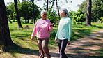 Fitness, old people and friends walk at park for longevity advice, funny joke and health benefits. Active retirement, exercise lifestyle and happy women outdoor for conversation, laugh and wellness