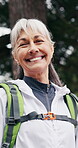 Senior, happy woman and face in forest for hiking adventure, active retirement and outdoor wellness. Hobby, pensioner and trekking break in woods with smile, fresh air and healthy aging with backpack