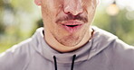 Fitness, mouth and man in nature with breathing, cardio fatigue and break with outdoor practice. Bokeh, dedication and athlete in park with sweat, training pause and exercise burnout with recovery.