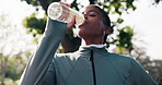 Fitness, woman and relax at park with drinking water, post workout hydration and break for cool down. Black person, thirsty athlete and happy with refreshing liquid, exercise recovery or satisfaction