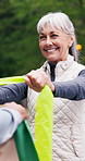 Stretching, fitness and old woman in park with resistance band, exercise and muscle strength. Happy, outdoor and senior person with equipment, trainer and breathe for workout, mobility and wellness