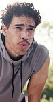 Tired, athlete and man with sweat, breathing or thinking after physical activity or exercise at park. Exhausted, runner and person with fatigue on break, outdoor and endurance post workout in nature