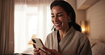 Phone, happy and woman in bedroom at hotel for guest review, online message and social media. Typing, travel and person with cellphone for accommodation, hospitality and website for connection