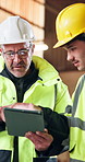 Construction team, tablet and engineer talking at site for development, building design or planning. Men, tech and speaking with worker for architecture idea, problem solving and project management