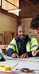 Carpenter, team and review in workshop with document, blueprint and drawing for manufacturing. People, talking and paperwork in factory for carpentry, floor plan and collaboration for joinery project