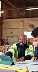 Carpenter, team and review in workshop with tablet, research and blueprint for manufacturing. People, reading and digital in factory with document, illustration and collaboration for joinery project