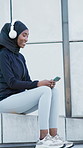 Black woman, headphones and phone on stairs for fitness, streaming and podcast for exercise break. Smile, muslim person or relax on steps with mobile, listening to music and sports audio for training