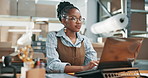 Laptop, woman and typing in startup for shipping status update, backlog dispatch and relief. Ecommerce, black person and happy with tech for urgent order process, finish daily manifest and logistics