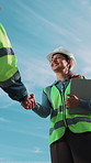 Engineer, woman and handshake with team at construction site, meeting or development partnership. Architecture collaboration, happy people or shaking hands, agreement or low angle with tablet outdoor