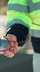 People, handshake and team at construction site, meeting or engineer with development partnership. Architecture collaboration, worker or shaking hands for renovation agreement, deal or cooperation