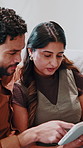 Couple, talking and tablet to relax in home with funny post, online entertainment or comedy movie. Happy man, woman and technology on lounge sofa with app subscription, connection or point for choice