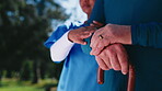Nurse, hands and old person with walking stick, outdoor and senior patient in nature and healthcare. Assisted living, caregiver and pensioner with cane, retirement and elderly care for rehabilitation