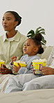 Parents, child and television at house with popcorn, streaming and latest cartoon for bonding. African family, kid and tv show in lounge with snack, watching movies and animation video for childcare