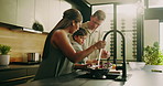 Family, kitchen and cleaning food in home for hygiene, washing vegetables or meal prep together. Mom, dad and rinsing with natural organic ingredients for dirt, germ or bacteria removal in house