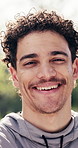 Face, happy and man outdoor for fitness, exercise and break for wellness and active hobby in park. Nature, portrait and person with smile for workout, healthy lifestyle and training with fresh air