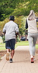 Back, running and senior couple in park for exercise, training and active together for health. Marriage, retirement and elderly man with woman outdoor for wellness, workout and cardio for fitness