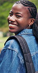 Walking, face and woman at college outdoor for travel, journey and trip to class for learning. Portrait, campus and African student with backpack for education, studying and knowledge at university