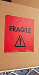 Logistics, fragile and label in storage with box, careful delivery and quality control of ecommerce. Cardboard, package and sticker at warehouse for delicate warning, prevent damage and distribution